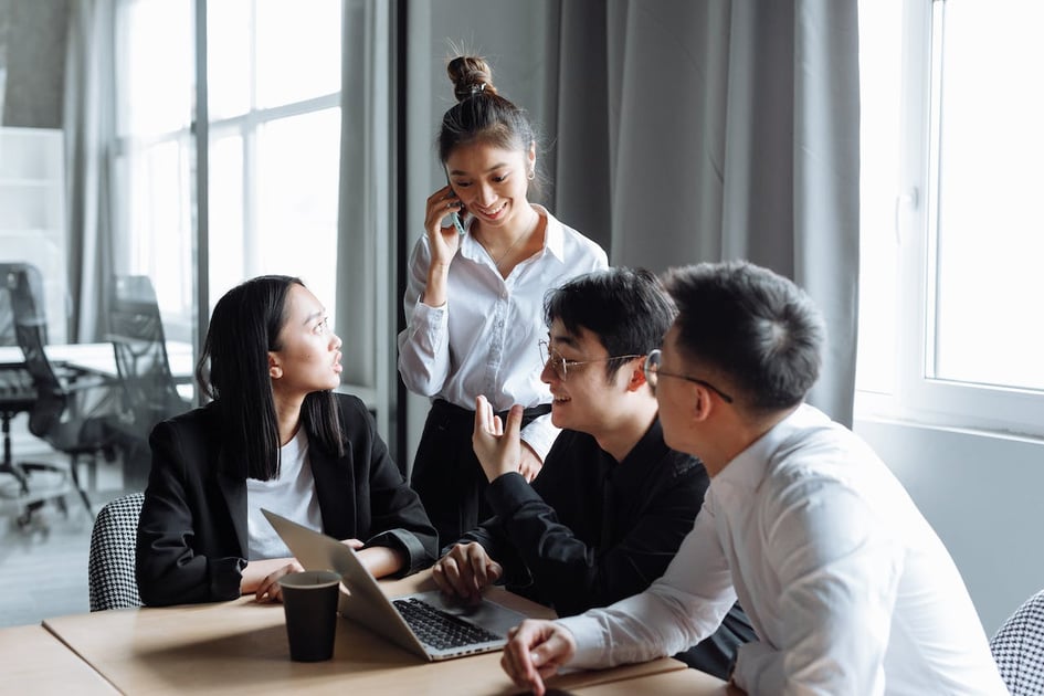 Professional team discussing global employment outsourcing solutions - EOR blog from TopSource