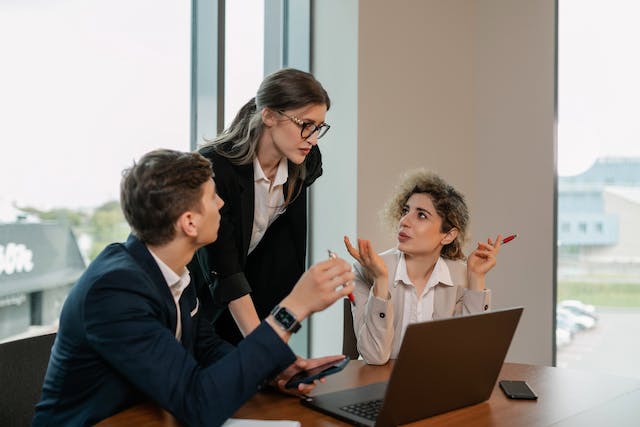Business team discussing global payroll outsourcing considerations | TopSource blog