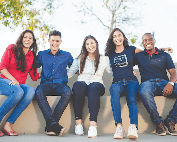 Diverse Employees Sat Together | TopSource Blog - 5 Factors to Consider When Hiring International Employees
