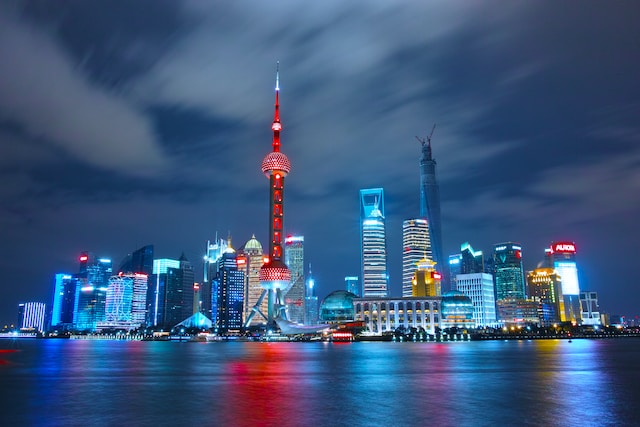 The Shanghai city skyline, brightly illuminated at night, spotlighting China’s contribution to the East Asia market.