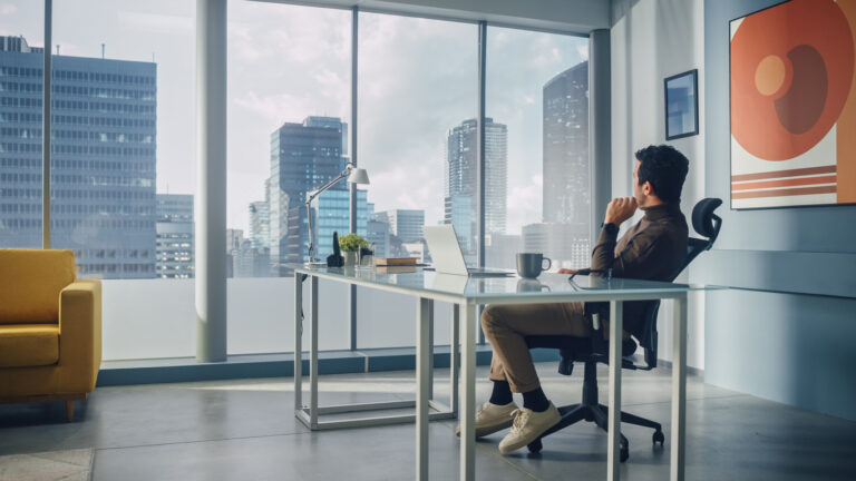 A professional working remotely in a modern Berlin office, highlighting the transition from contractor to EOR in Germany to avoid false self-employment