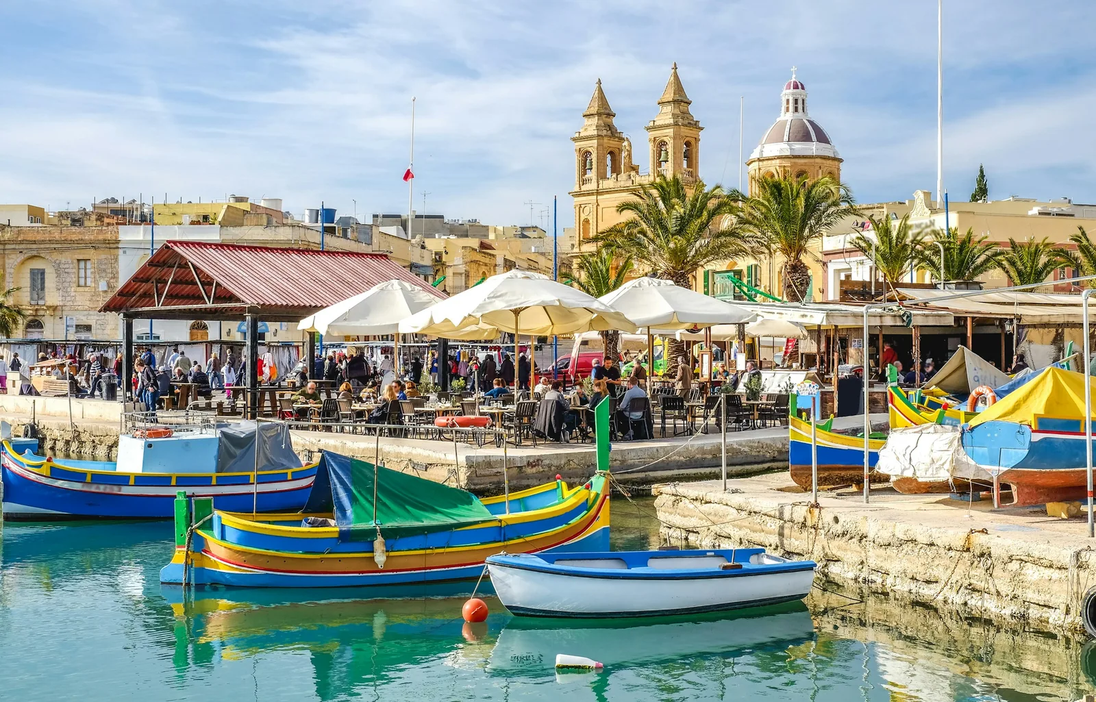 Traditional luzzu fishing boats in Marsaxlokk harbour, Malta