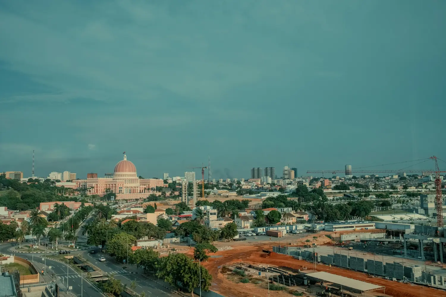 The Luanda skyline with the pink domed National Assembly building, apartment towers and construction cranes, Angola