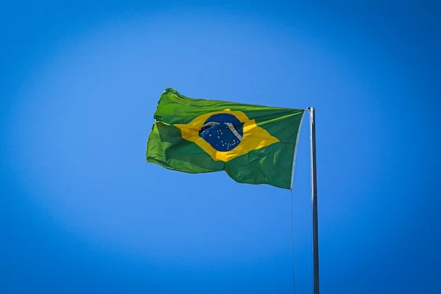 The Brazilian flag flying against a clear blue sky, Brazil