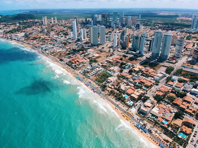 An aerial view of the high-rise coastline and turquoise water at Ponta Negra in Natal, Rio Grande do Norte, Brazil