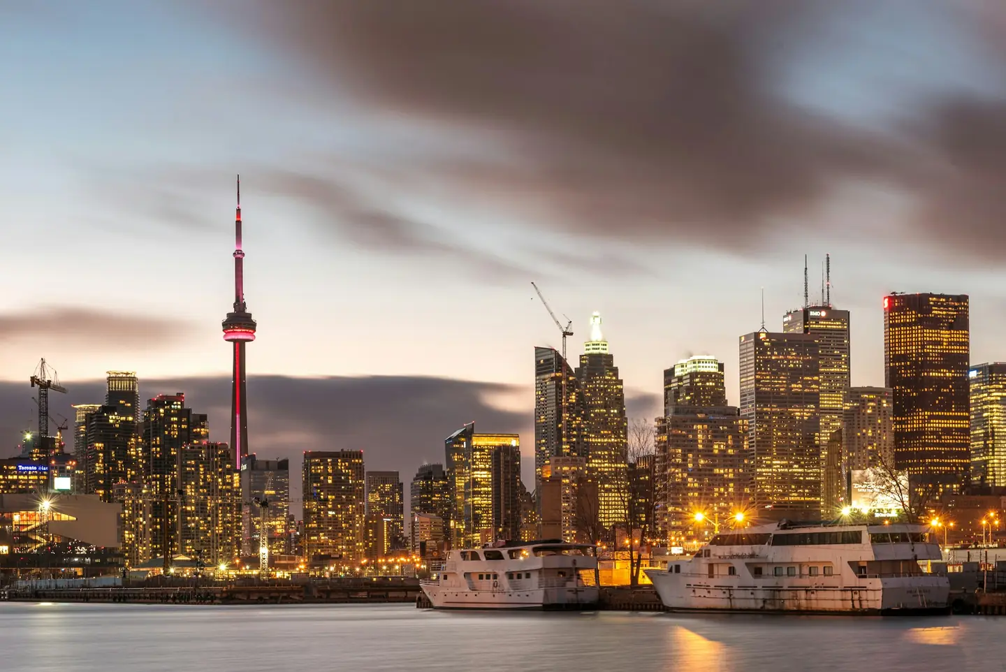 Toronto skyline and CN Tower at dusk over Lake Ontario, Canada