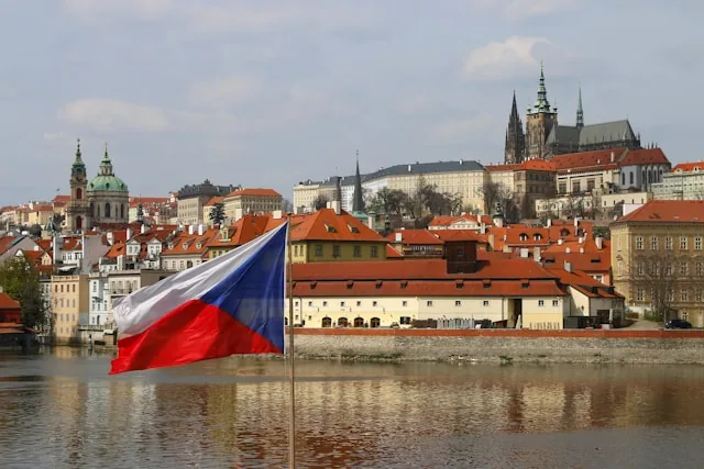 Prague Castle and St. Vitus Cathedral above the Vltava with the Czech flag