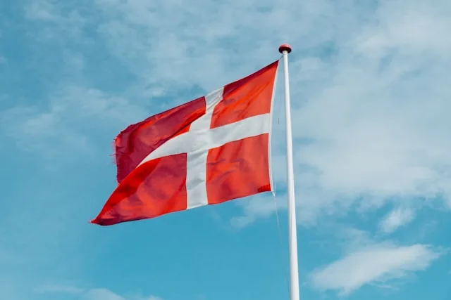 The Danish national flag (Dannebrog) flying against a blue sky