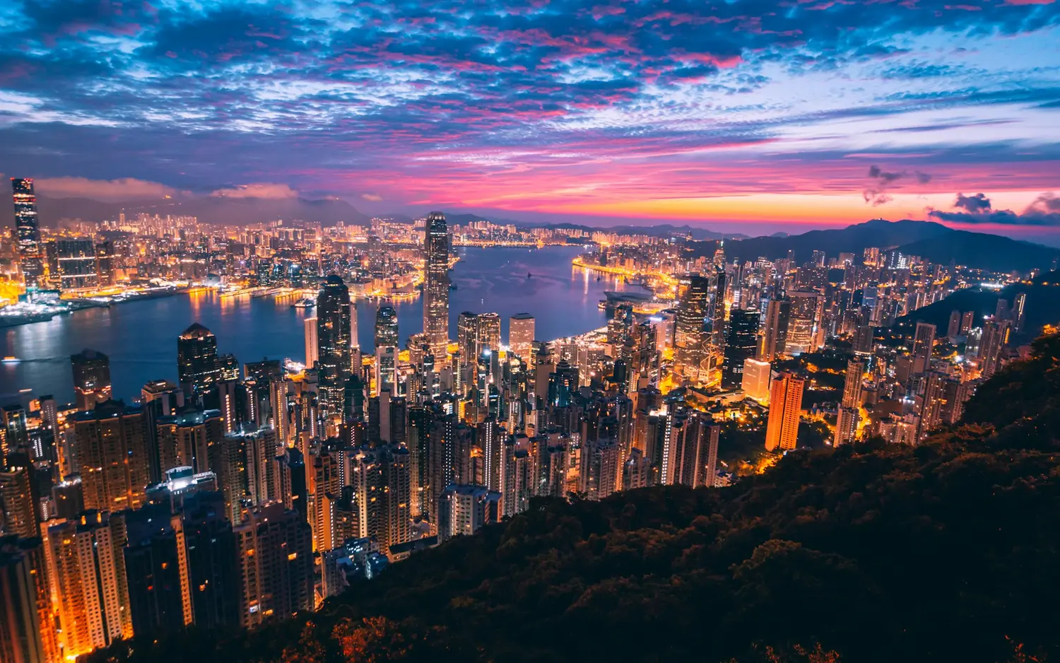 Hong Kong Island skyline and Victoria Harbour at sunset seen from The Peak