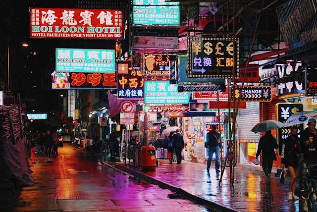 Neon signs above a busy street at night in Mong Kok, Hong Kong