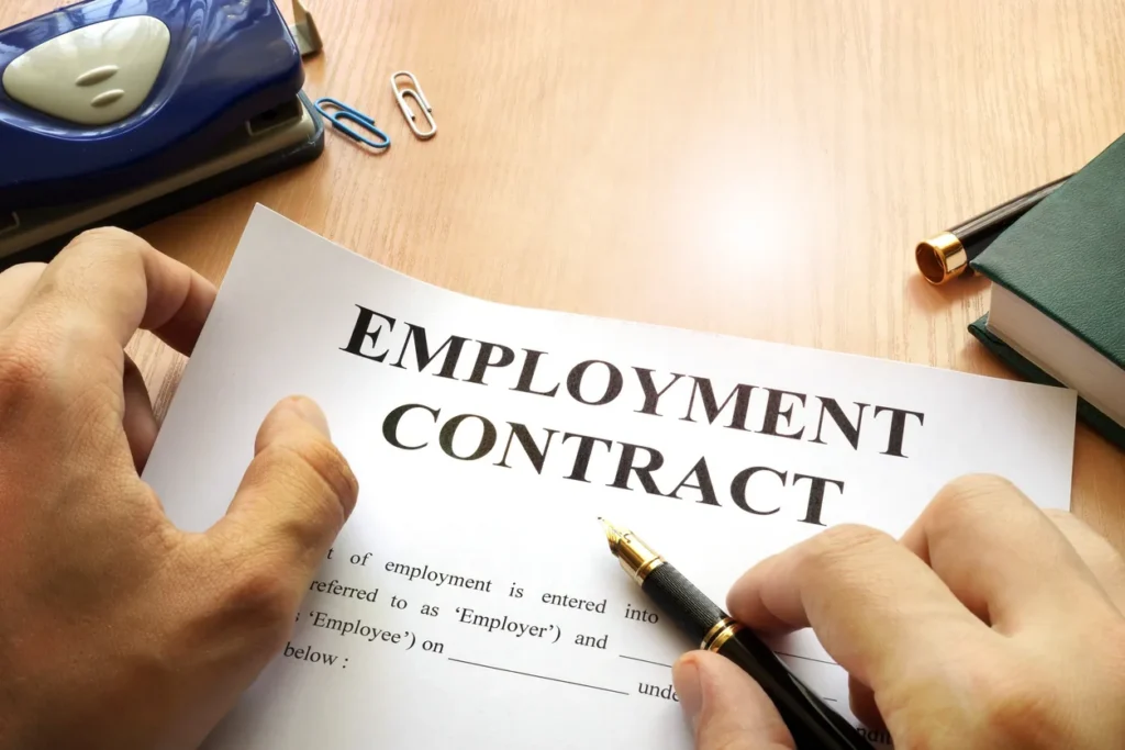 Employment contract being signed, representing compliant hiring in India through an Employer of Record