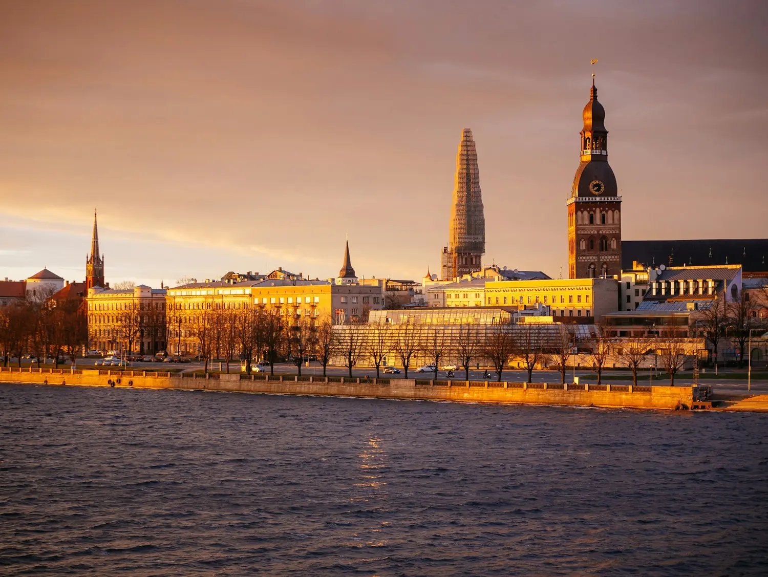 Riga Cathedral and the Old Town waterfront on the Daugava river at sunset, Latvia