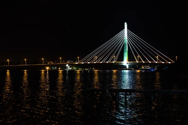 A cable-stayed bridge lit up at night over the lagoon in Lagos, Nigeria