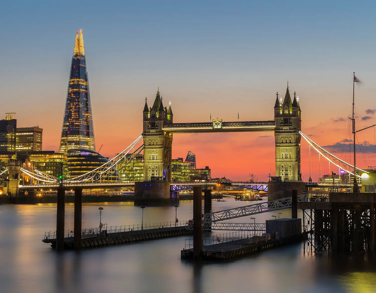 Tower Bridge and The Shard lit up over the River Thames at sunset, London, United Kingdom