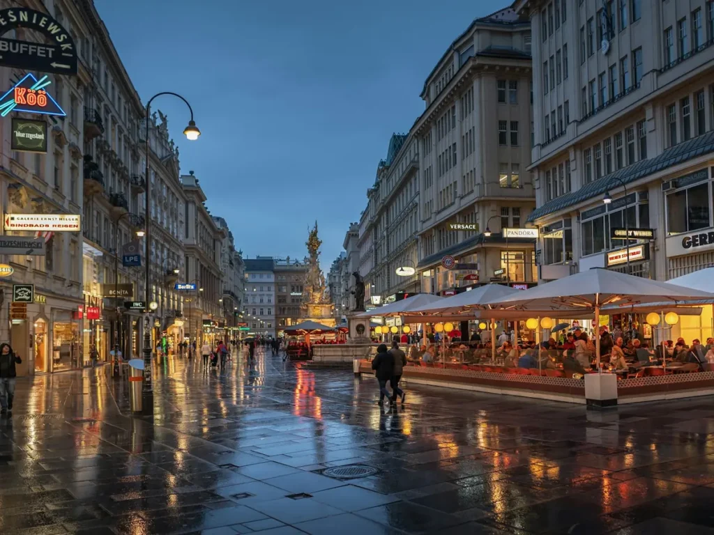 Shops and cafe terraces along the Graben with the Plague Column, Vienna, Austria