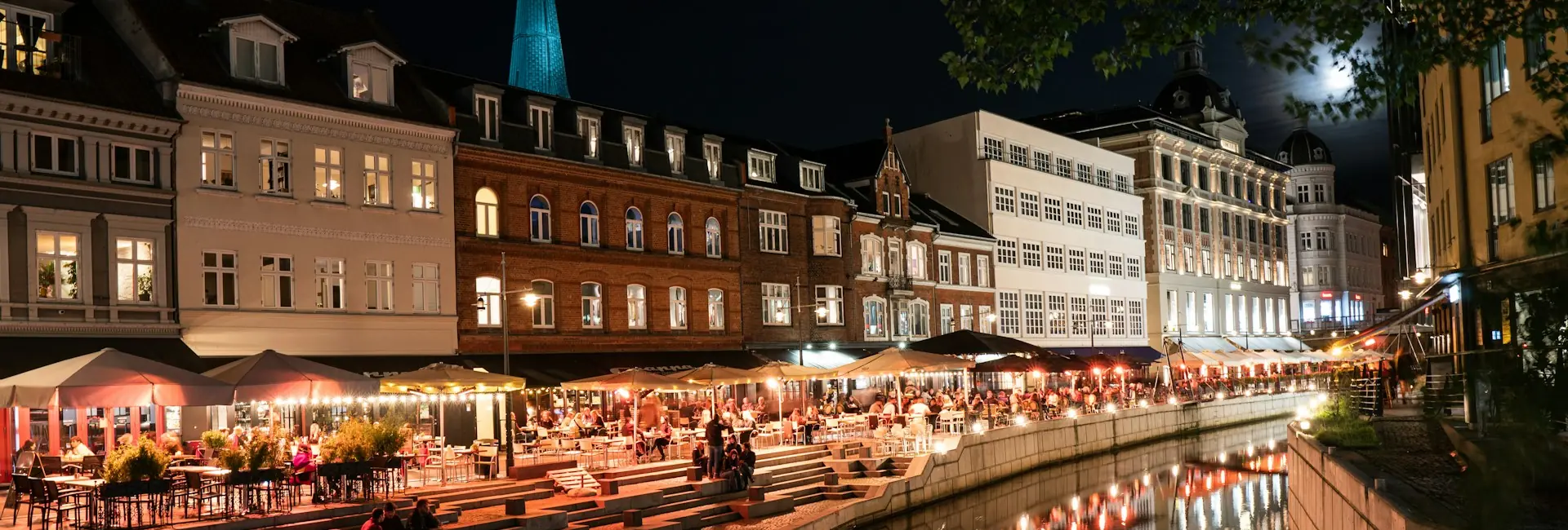 Åboulevarden along the Aarhus River at night, with the cathedral spire behind, Aarhus, Denmark
