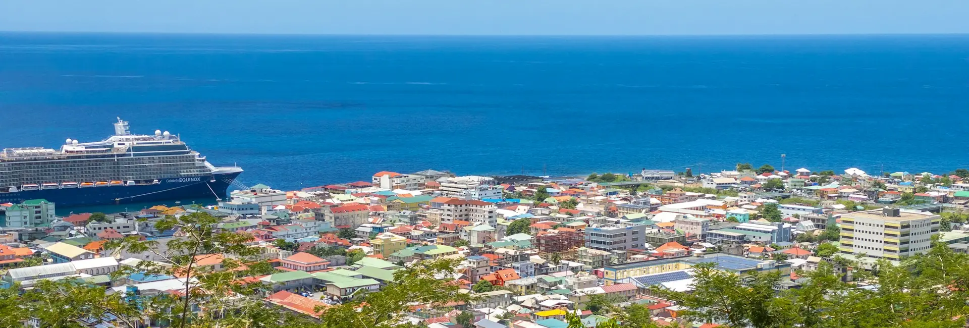 The colourful rooftops of Roseau and the Caribbean Sea, with a cruise ship docked at the waterfront, Dominica