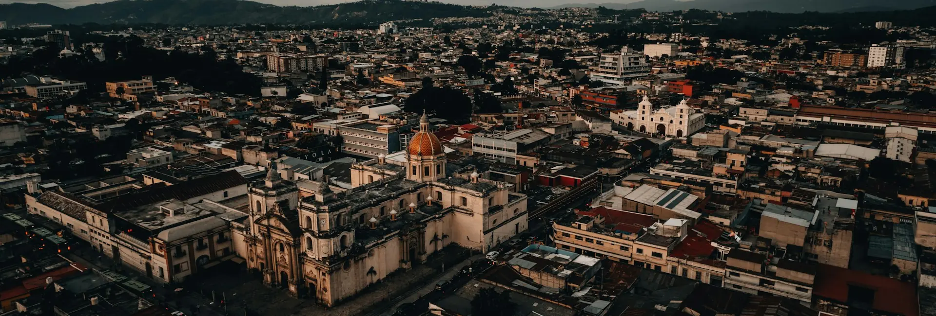 Aerial view of central Guatemala City with a domed church and the surrounding hills, Guatemala