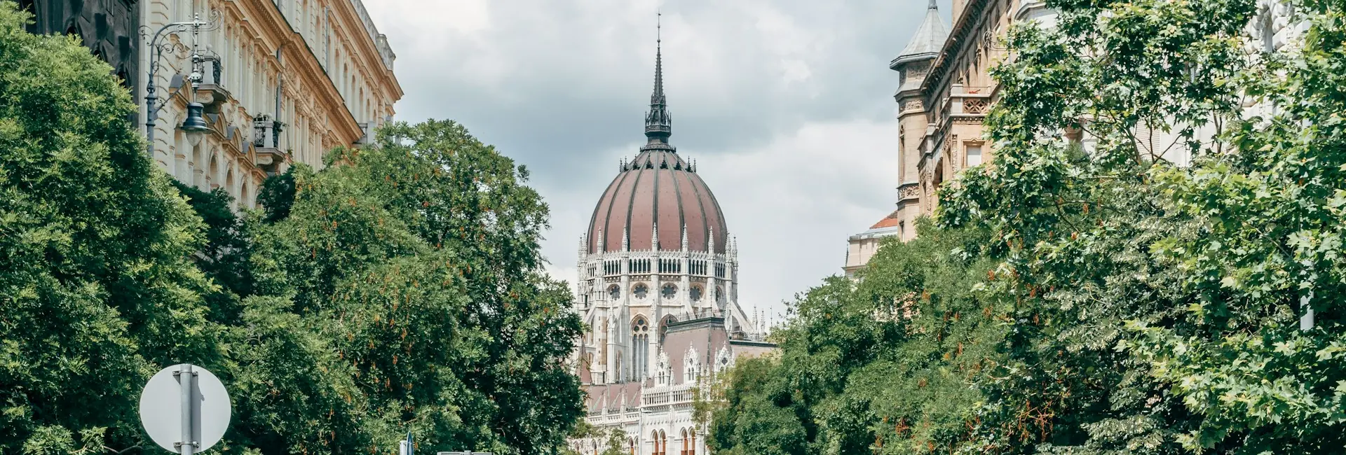 A tree-lined street in central Budapest leading to the dome of the Hungarian Parliament, Budapest, Hungary