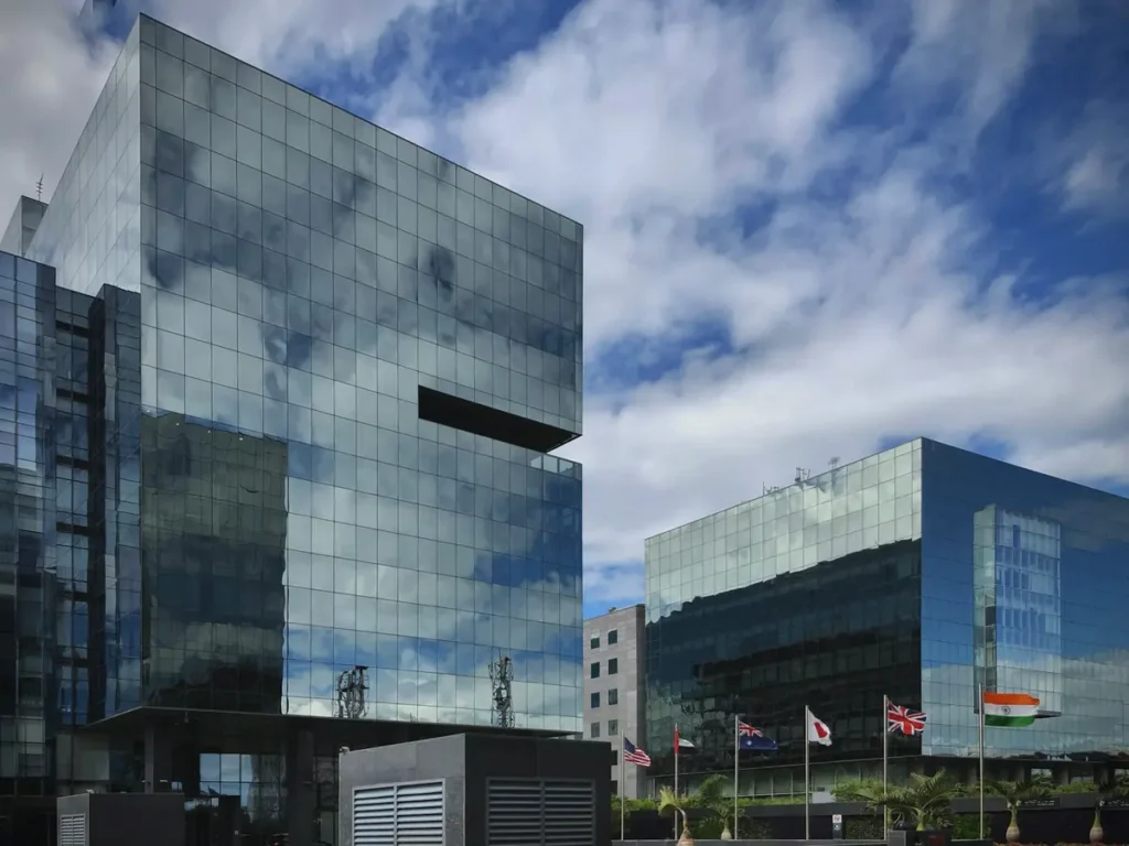 Glass office towers at the World Trade Center in Kharadi, Pune, with the Indian flag flying in front, India
