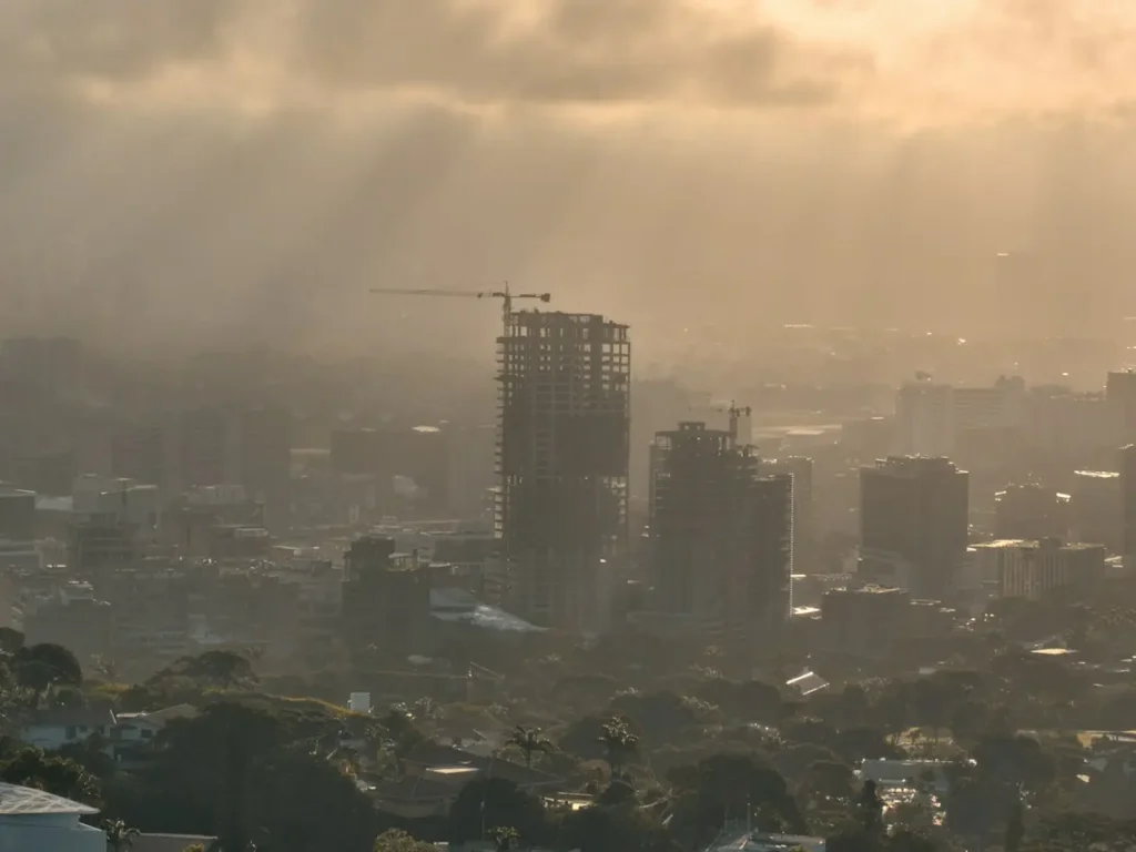 Towers under construction rising above the trees of Caracas at dawn, Venezuela