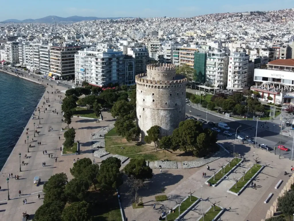 The White Tower, the seafront promenade and the city rising behind it, Thessaloniki, Greece