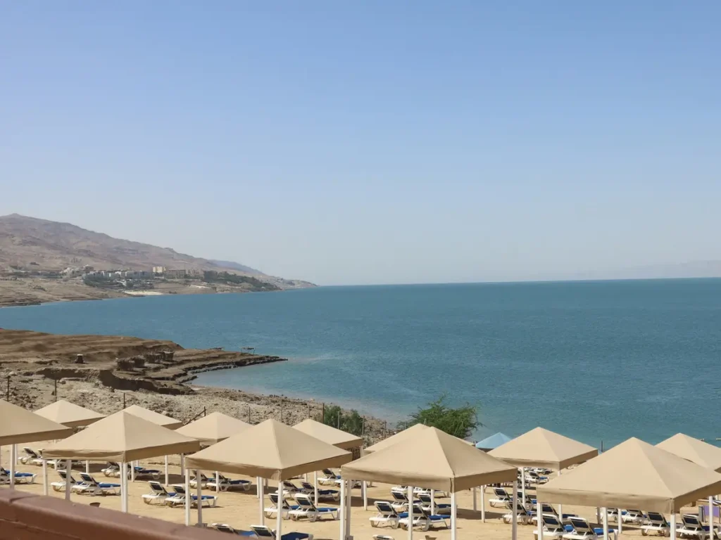 Beach umbrellas at a resort on the Jordanian shore of the Dead Sea, Jordan