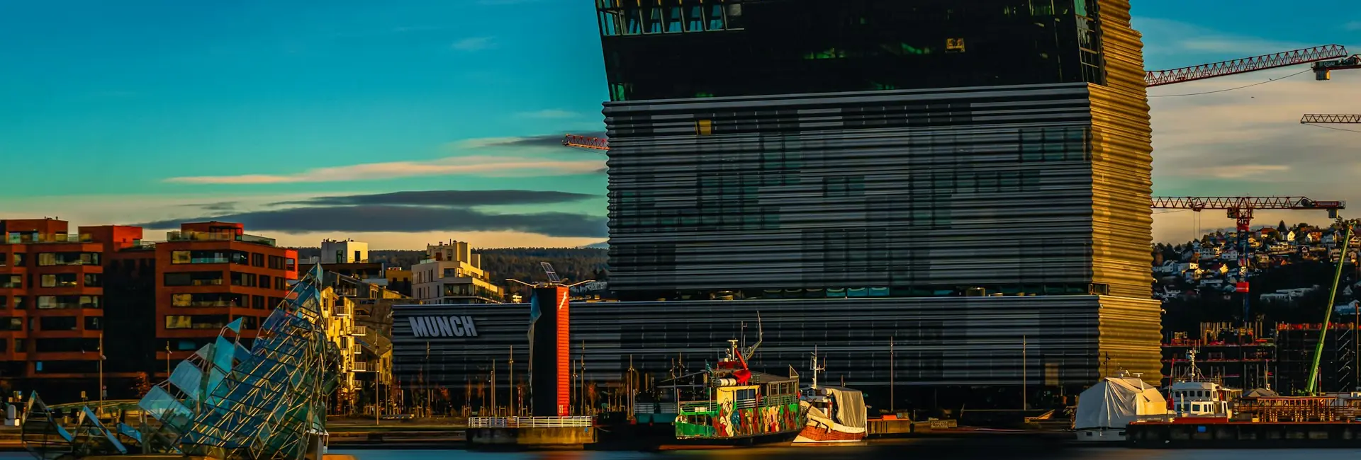The MUNCH museum and the She Lies sculpture on the Oslofjord waterfront in Bjorvika, Oslo, Norway