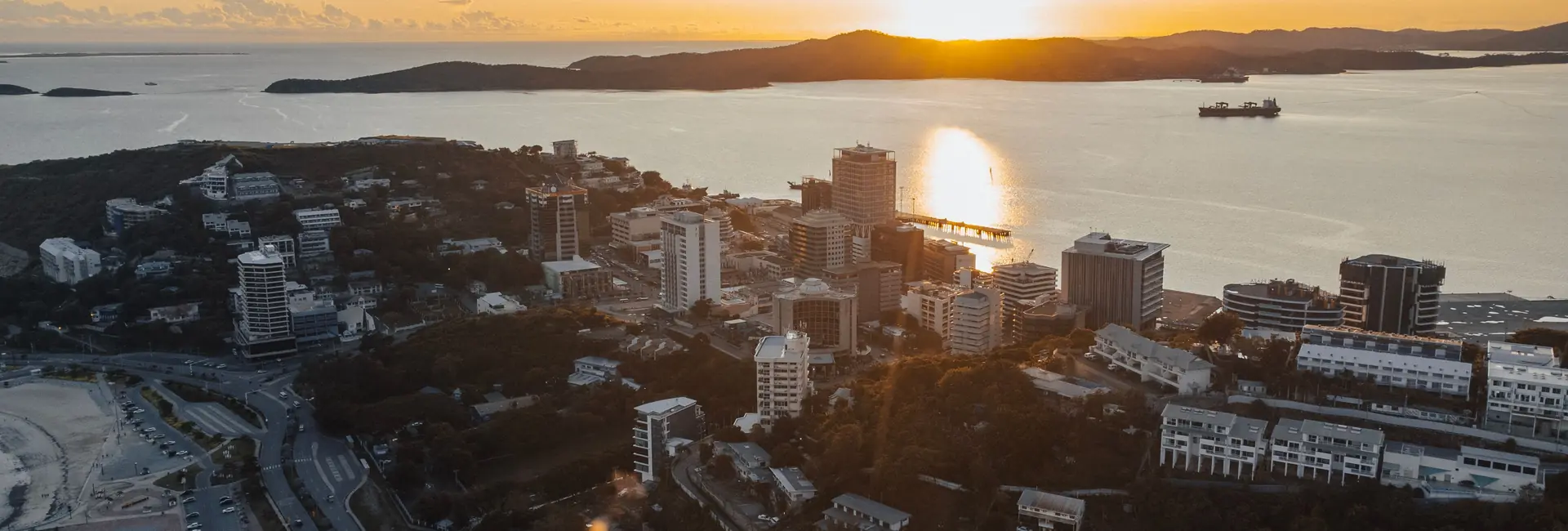 Office towers of downtown Port Moresby above the harbour at sunset, Papua New Guinea